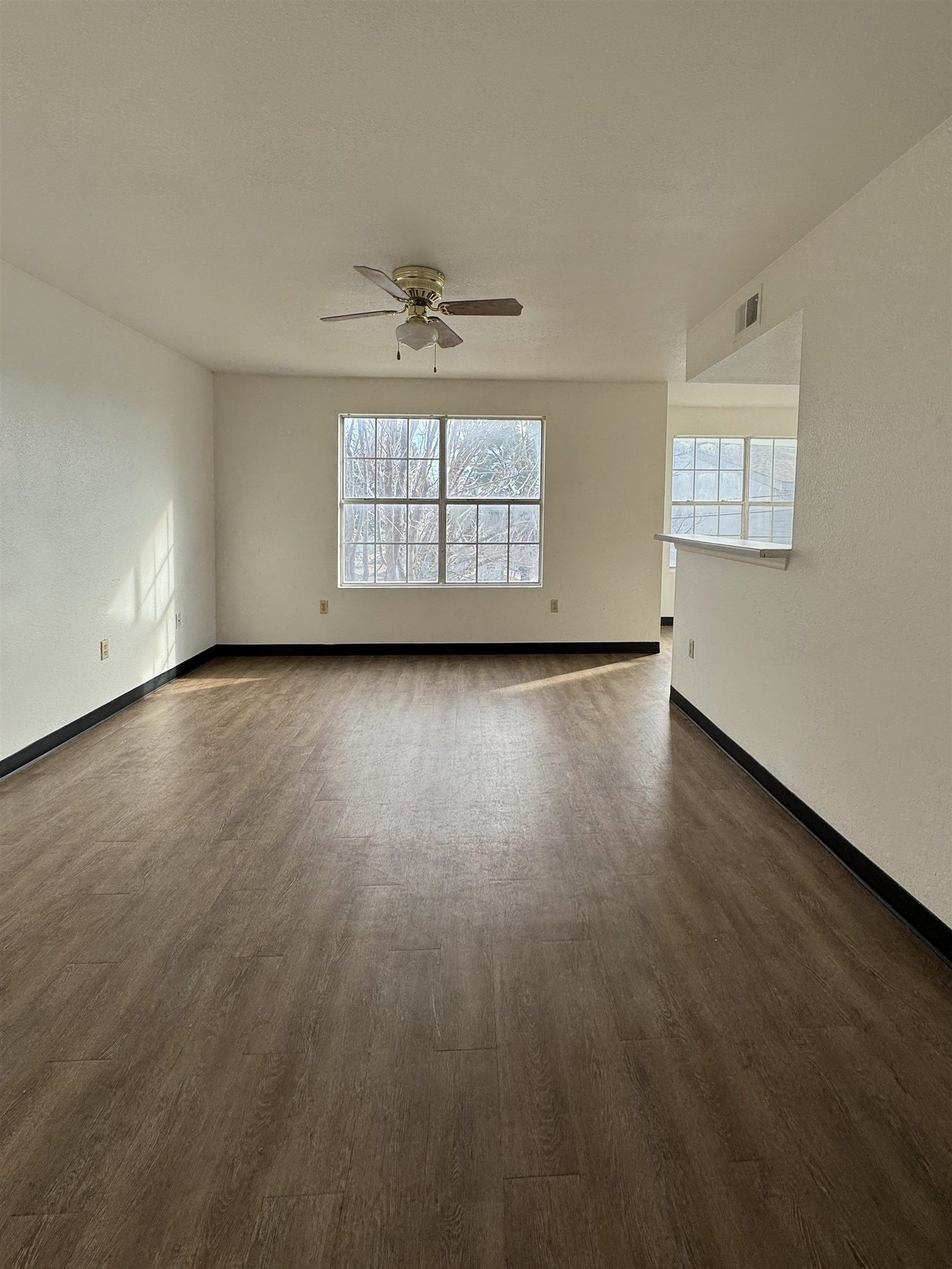 Living room with ceiling fan at Avalon Cove